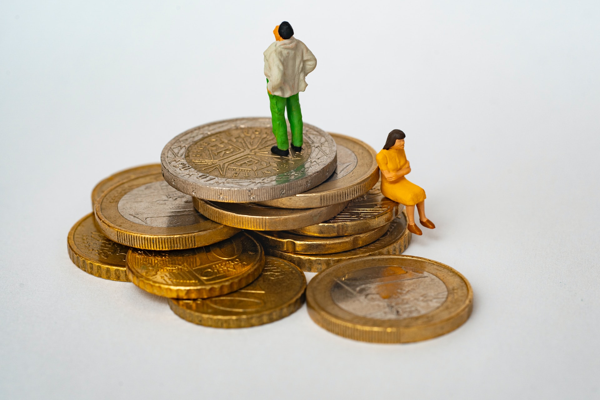 Figurines standing on coins/understanding Financial and Property Arrangements in Divorce