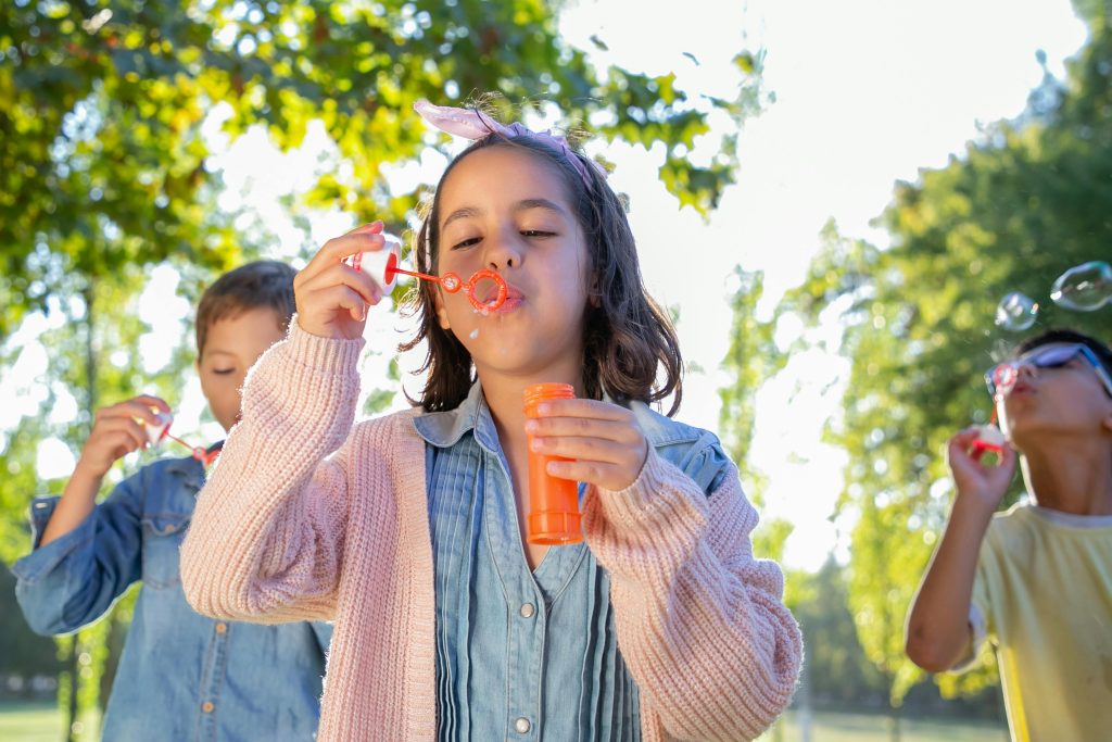 children blowing bubbles